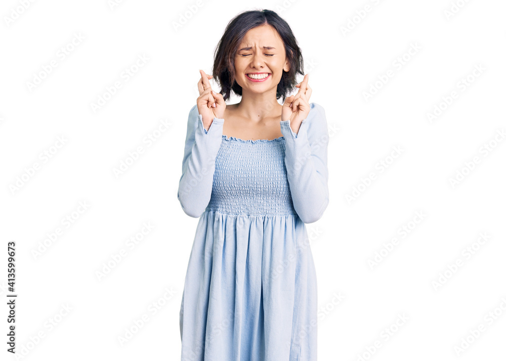Young beautiful girl wearing casual clothes gesturing finger crossed smiling with hope and eyes closed. luck and superstitious concept. Young beautiful girl wearing casual clothes gesturing finger crossed smiling with hope and eyes closed. luck and superstitious concept.