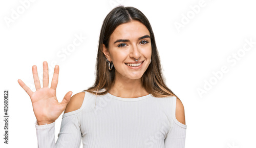 Wallpaper Mural Young hispanic woman wearing casual clothes showing and pointing up with fingers number five while smiling confident and happy. Torontodigital.ca