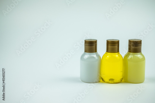 Three bottles one near each other on a white table