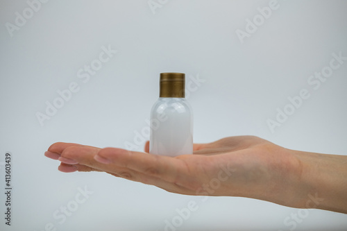 A photo of someone holding a bottle of body lotion from hotel