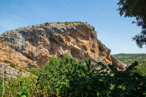 vulture nests on the mountain wall in a natural landscape in the area of Alquezar, Huesca, Spain.