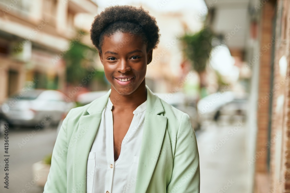 Young african american businesswoman smiling happy standing at the city Young african american businesswoman smiling happy standing at the city