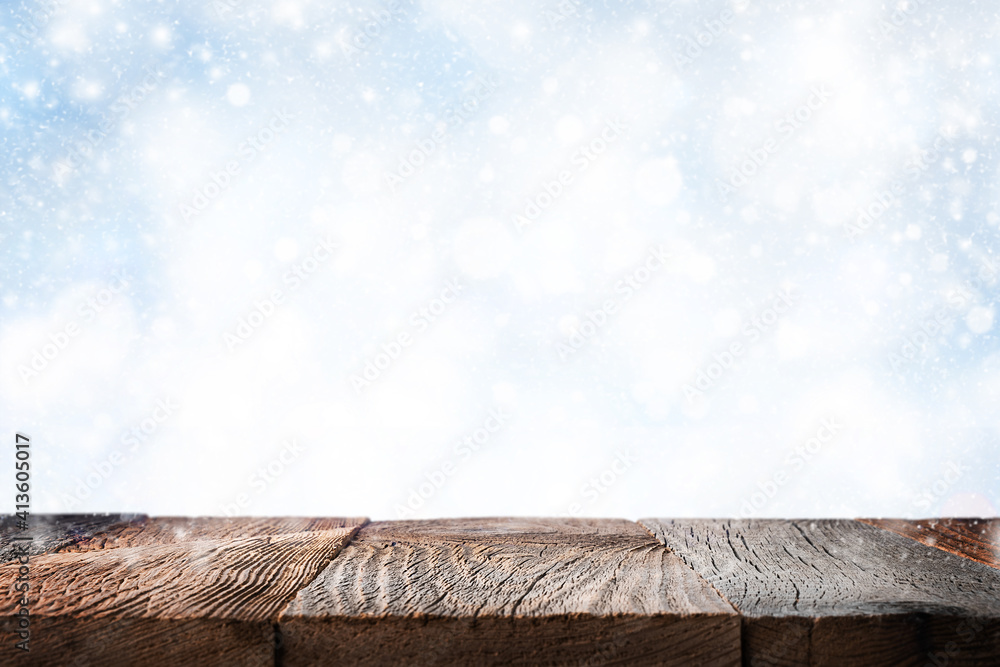 Empty wooden table surface ove blue winter background with snow Empty wooden table surface ove blue winter background with snow