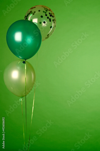 Concept of St. Patrick. Green balloons on green background, copy space for text