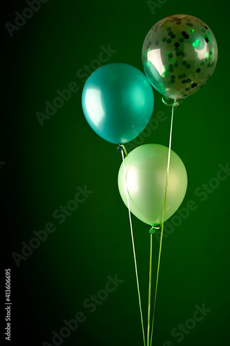 Concept of St. Patrick. Green balloons on dark background, copy space for text