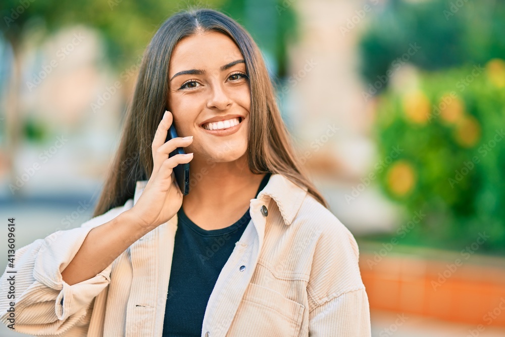 Young hispanic girl smiling happy talking on the smartphone at the park. Young hispanic girl smiling happy talking on the smartphone at the park.