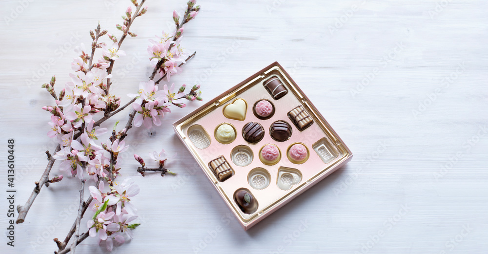 Box of fine chocolate pralines and almond blossom brunches Box of fine chocolate pralines and almond blossom brunches