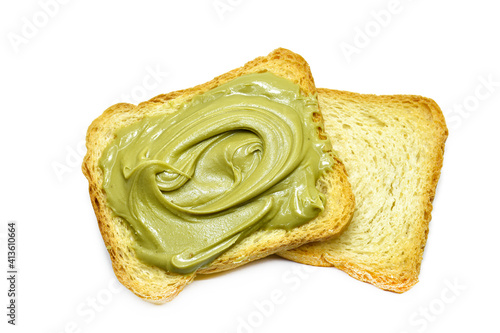 toast with pistachio cream lying on plain toasts isolated on white.