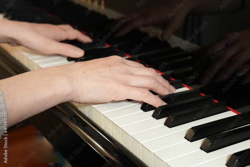 Fototapeta premium Female Hands Playing a Grand Piano