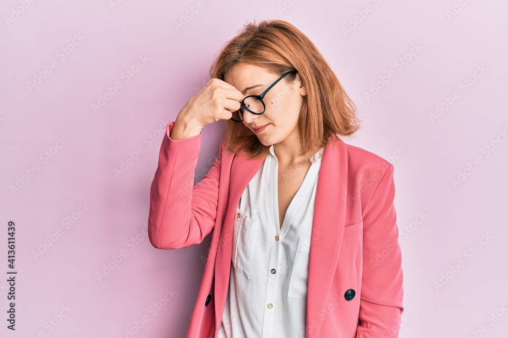 Young caucasian woman wearing business style and glasses tired rubbing nose and eyes feeling fatigue and headache. stress and frustration concept.