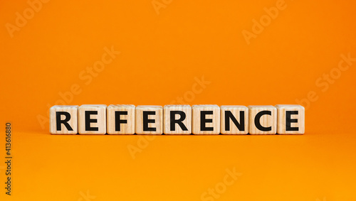 Reference symbol. Wooden cubes with the word 'reference'. Beautiful orange background. Business and reference concept. Copy space. photo