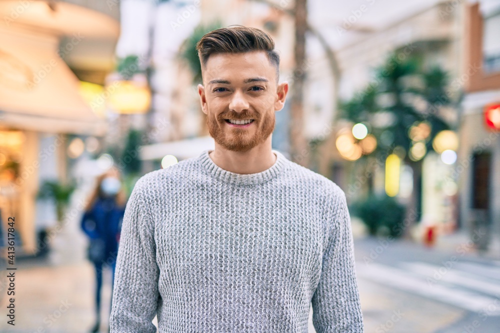 Fototapeta premium Young caucasian man smiling happy standing at the city.