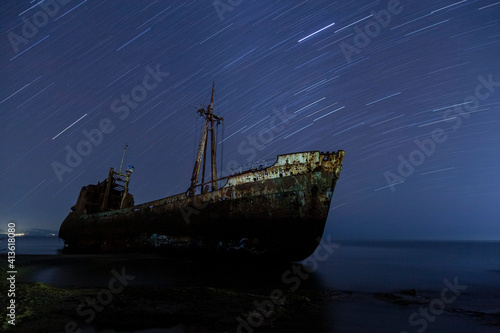 Shipwreck on shore, the remains of an old contraband ship, to be seen at the shore of Valtaki, near Gytheio town, Peloponnese, Greece. photo