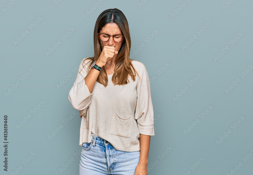 Young woman wearing casual clothes and glasses feeling unwell and coughing as symptom for cold or bronchitis. health care concept. Young woman wearing casual clothes and glasses feeling unwell and coughing as symptom for cold or bronchitis. health care concept.