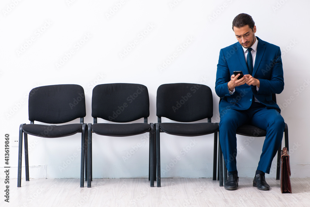 Young businessman waiting for an interview at hall Young businessman waiting for an interview at hall