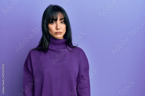 Young brunette woman with bangs wearing turtleneck sweater depressed and worry for distress, crying angry and afraid. sad expression. © Krakenimages.com
