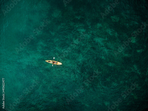 Aerial overhead view of fishing kayks on the coastline of the Mediterranean Sea, Marbella, Malaga, Spain.