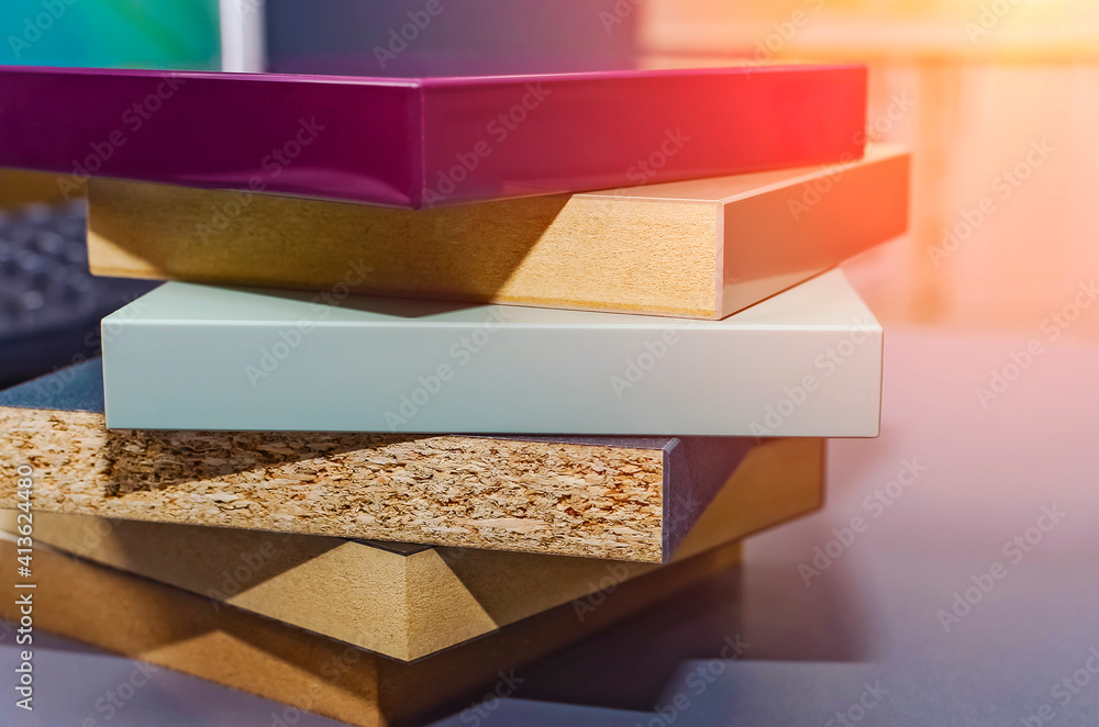 Naklejka premium samples of multi-colored finishing material based on laminated chipboard and MDF, close-up.