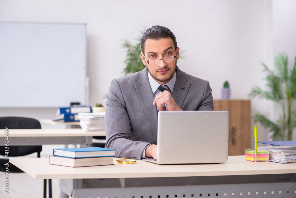 Young male employee working in the office Young male employee working in the office