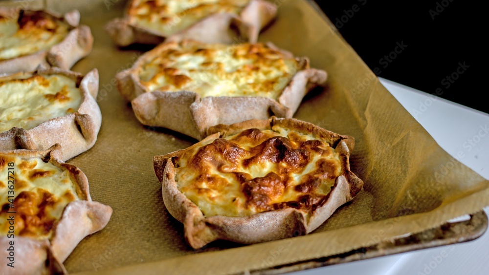 National Rye dough pies with potato filling. National Karelian food wicket close-up on on the baking dish. Alternative flour baked goods without sugar and gluten, authentic baked goods National Rye dough pies with potato filling. National Karelian food wicket close-up on on the baking dish. Alternative flour baked goods without sugar and gluten, authentic baked goods