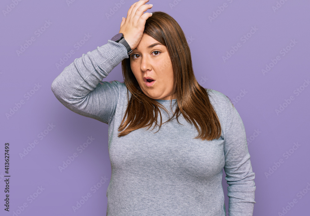 Beautiful brunette plus size woman wearing casual clothes surprised with hand on head for mistake, remember error. forgot, bad memory concept. Beautiful brunette plus size woman wearing casual clothes surprised with hand on head for mistake, remember error. forgot, bad memory concept.