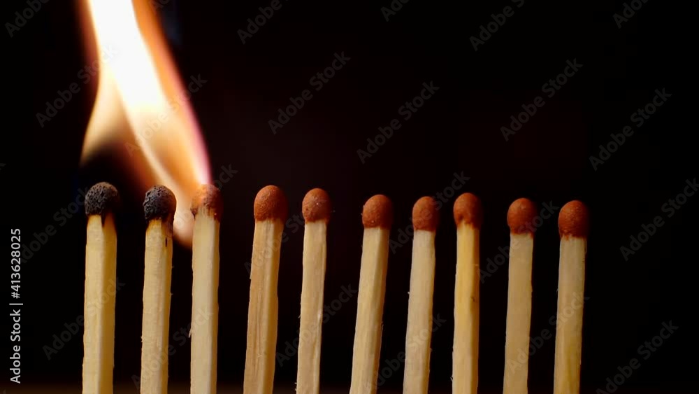 matches standing in a row light up and burn out. Close-up matches standing in a row light up and burn out. Close-up
