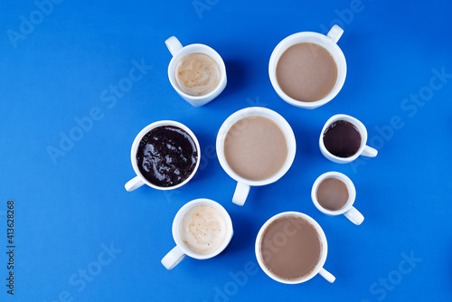 Cups of coffee on a blue background