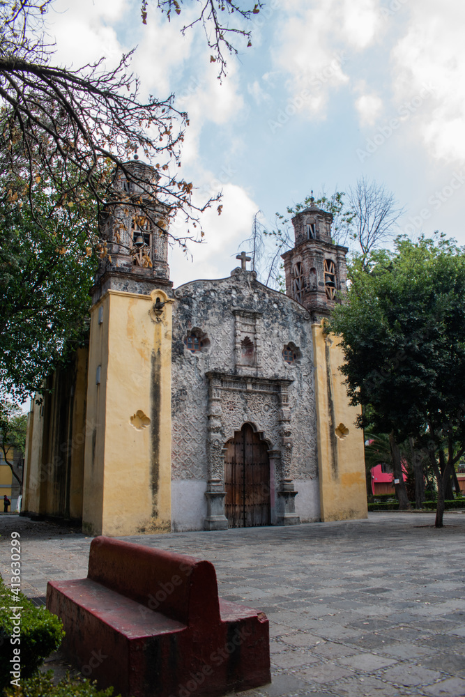 Fototapeta premium Old Mexican Church surrounded by trees in Coyoacan