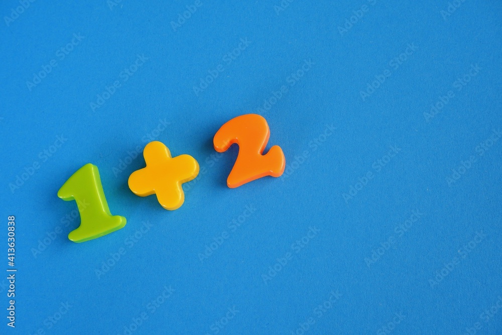 Obraz premium adding one and two on blue background