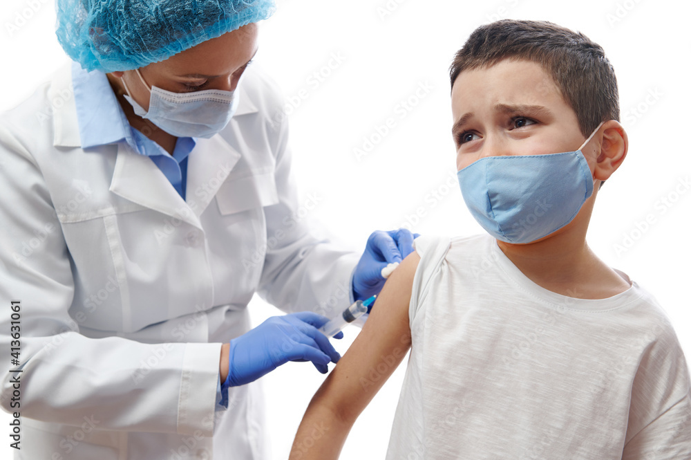 Doctor making injection on boy's hand. Vaccination on white background. Boy afraid of vaccination and injection. Doctor making injection on boy's hand. Vaccination on white background. Boy afraid of vaccination and injection.