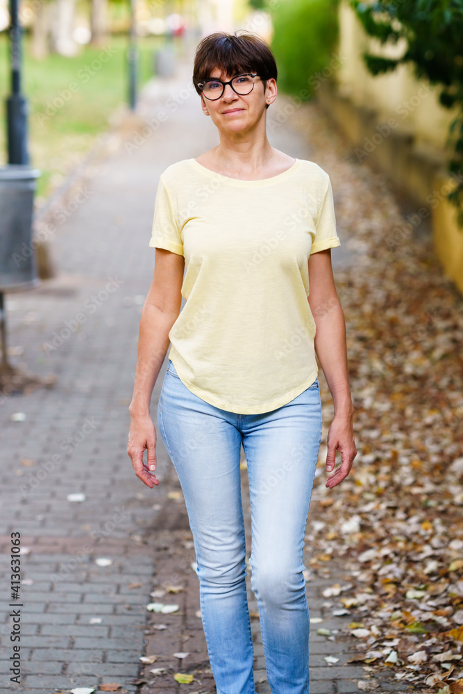 Beautiful Middle-aged woman walking down the street Beautiful Middle-aged woman walking down the street