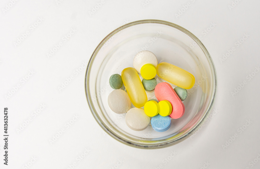 Colorful pills vitamins and antibiotics lie beautifully on a white background Colorful pills vitamins and antibiotics lie beautifully on a white background