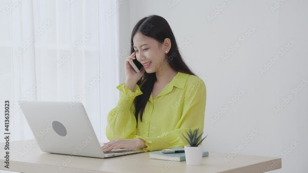 Young asian business woman working form home office and call phone for success at home, businesswoman using laptop computer on desk, female talking smartphone at workplace, communication concept. Young asian business woman working form home office and call phone for success at home, businesswoman using laptop computer on desk, female talking smartphone at workplace, communication concept.