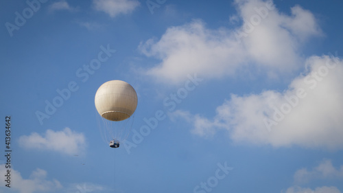 hot air balloon in the blue sky among the clouds