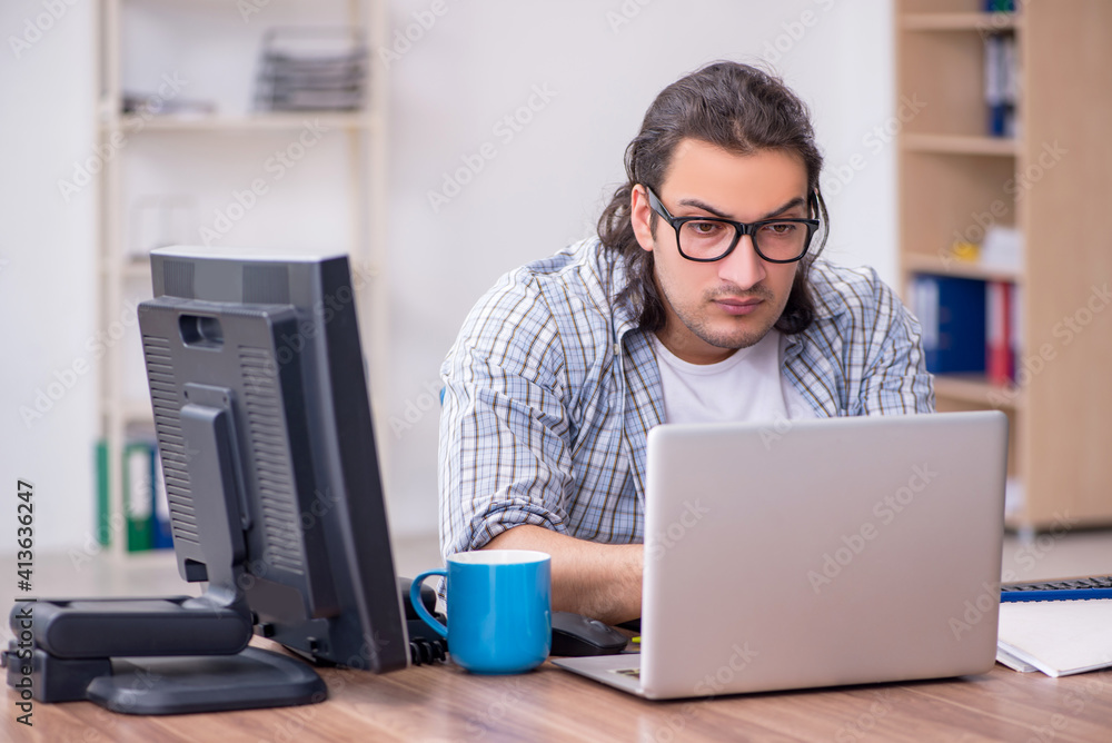 Young male it specialist working in the office Young male it specialist working in the office
