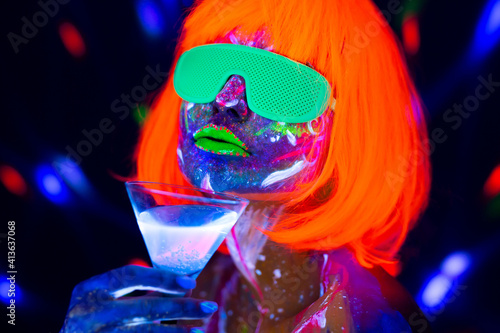 Photography Fashion model woman drinking alcoholic cocktail in neon light, disco night club