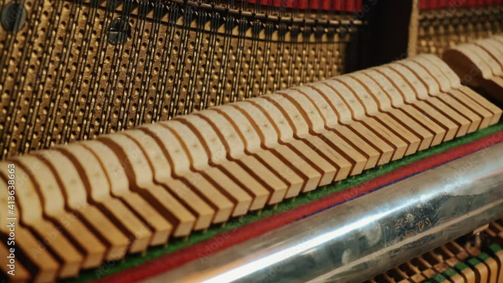 Beautiful playing the piano in the studio close-up general plan. hammers and piano keys play together in a piece. Beautiful playing the piano in the studio close-up general plan. hammers and piano keys play together in a piece.