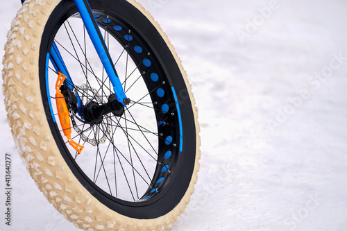  A fragment of a fatbike. Wheel with a wide elastic band in white, Selective focus. Copy space.