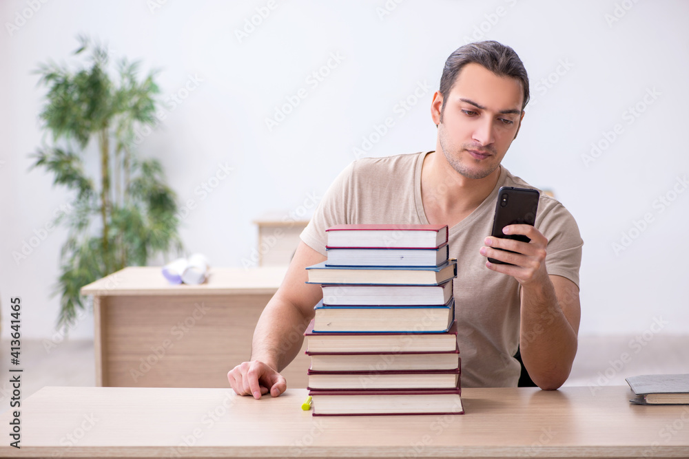 Young male student preparing for exams at library Young male student preparing for exams at library