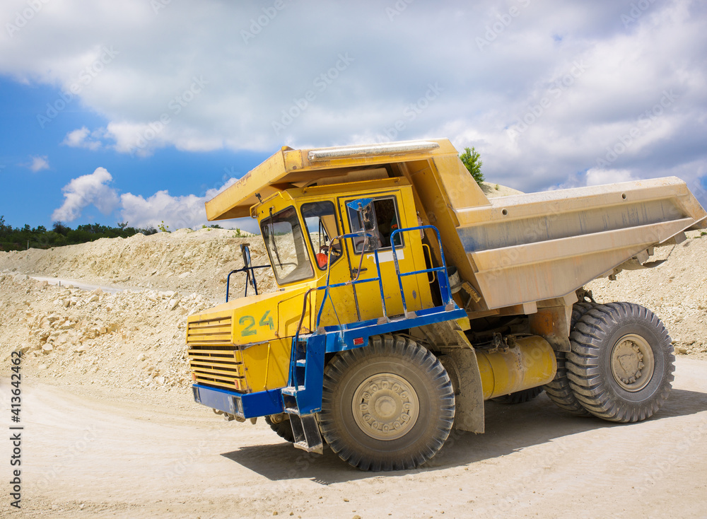 A large quarry dump truck loaded with rock. A large quarry dump truck loaded with rock.