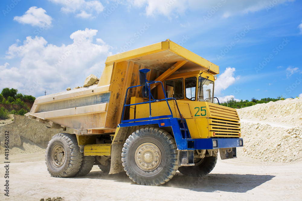 A large quarry dump truck loaded with rock. A large quarry dump truck loaded with rock.