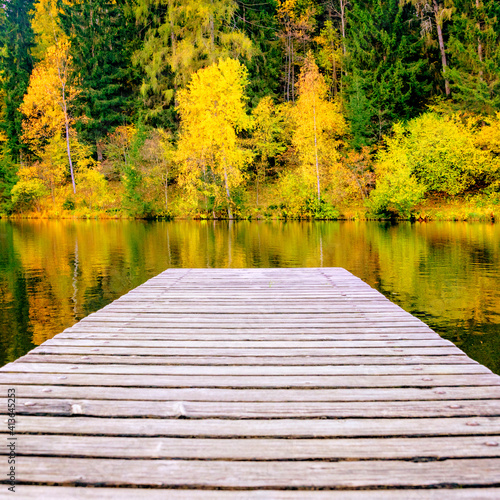 Wooden pier on a mountain lake. autumn landscape. calm
