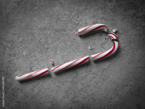 Moody Top-Down Shot of a Red and White Candy Cane that has Been Shattered into Multiple Pieces