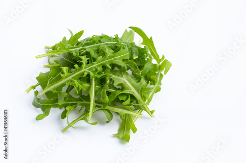 Fresh green rocket salad on white background.