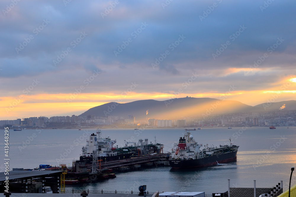 sunset over the harbor tanker