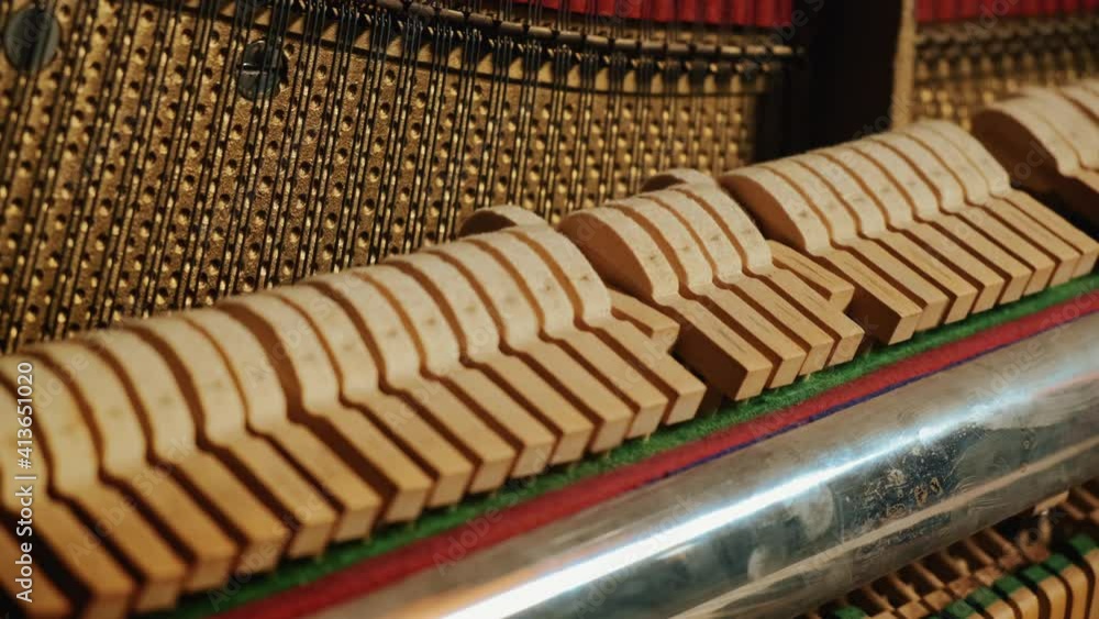 Beautiful playing the piano in the studio close-up general plan. hammers and piano keys play together in a piece. Beautiful playing the piano in the studio close-up general plan. hammers and piano keys play together in a piece.