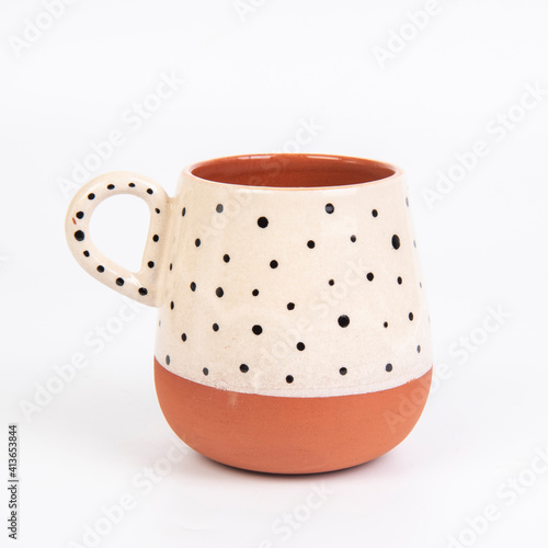 colorful handmade ceramic coffee cup on white