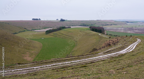 view of the up-faulted Southern edge of Pewsey Vale with copse woodland in the valley near Pewsey, Wiltshire