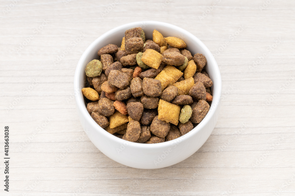 domestic pet dry food on wooden background. dried cat feed. above view domestic pet dry food on wooden background. dried cat feed. above view