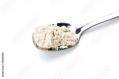dry wasabi powder on spoon isolated on a white background. above view